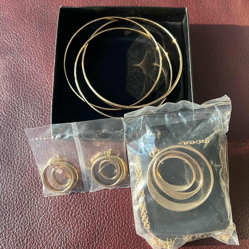Three piece set: earrings, necklace and bangles.